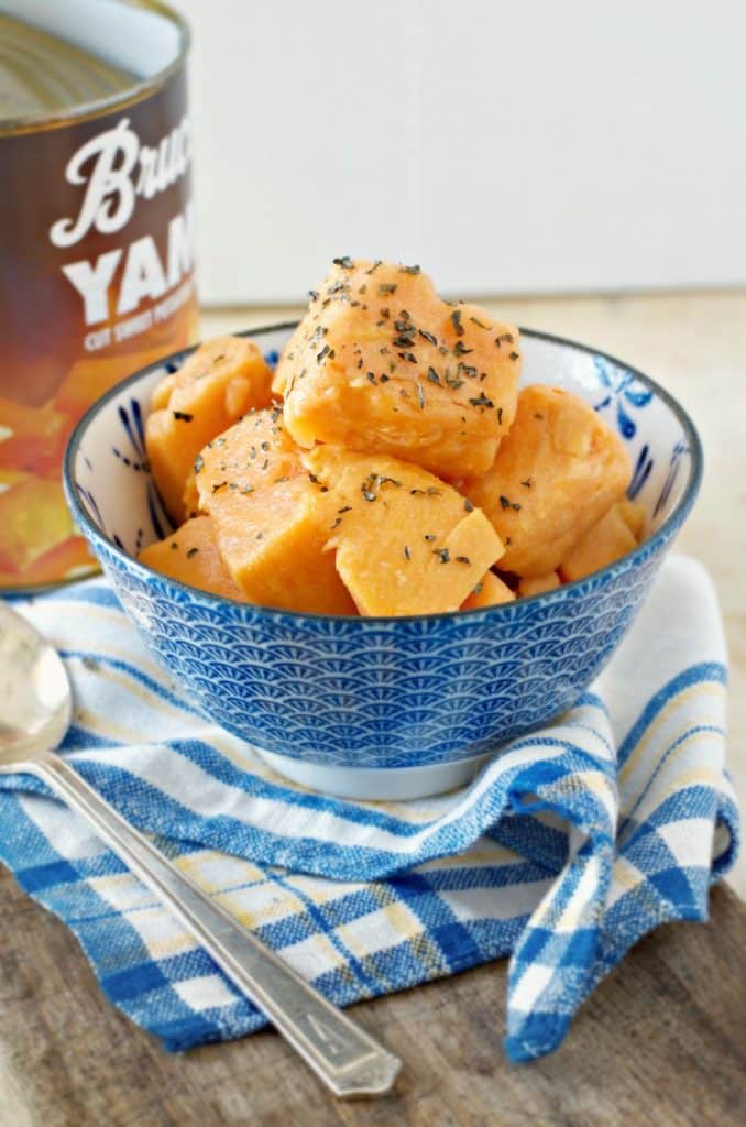 A photo from the side of a bowl of How to Cook Canned Yams on the Stove