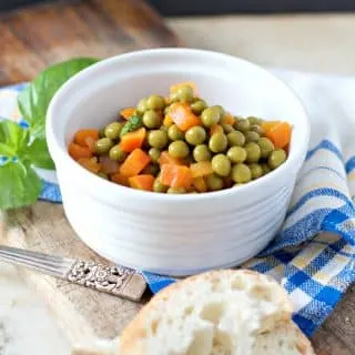 Sunlit from the side photo of a bowl of peas and carrots for HOW TO COOK CANNED PEAS AND CARROTS