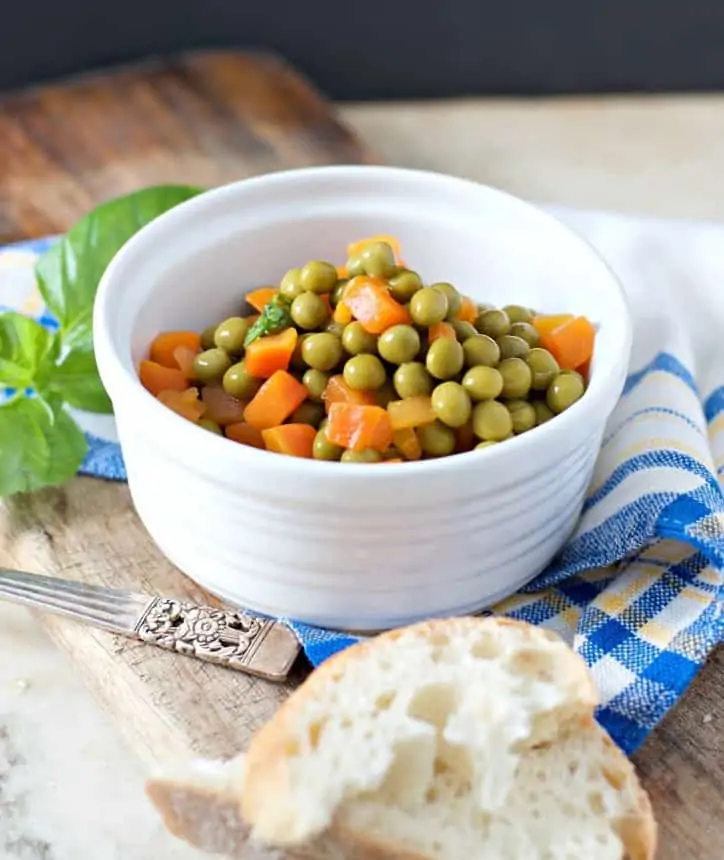 Sunlit from the side photo of a bowl of peas and carrots for HOW TO COOK CANNED PEAS AND CARROTS