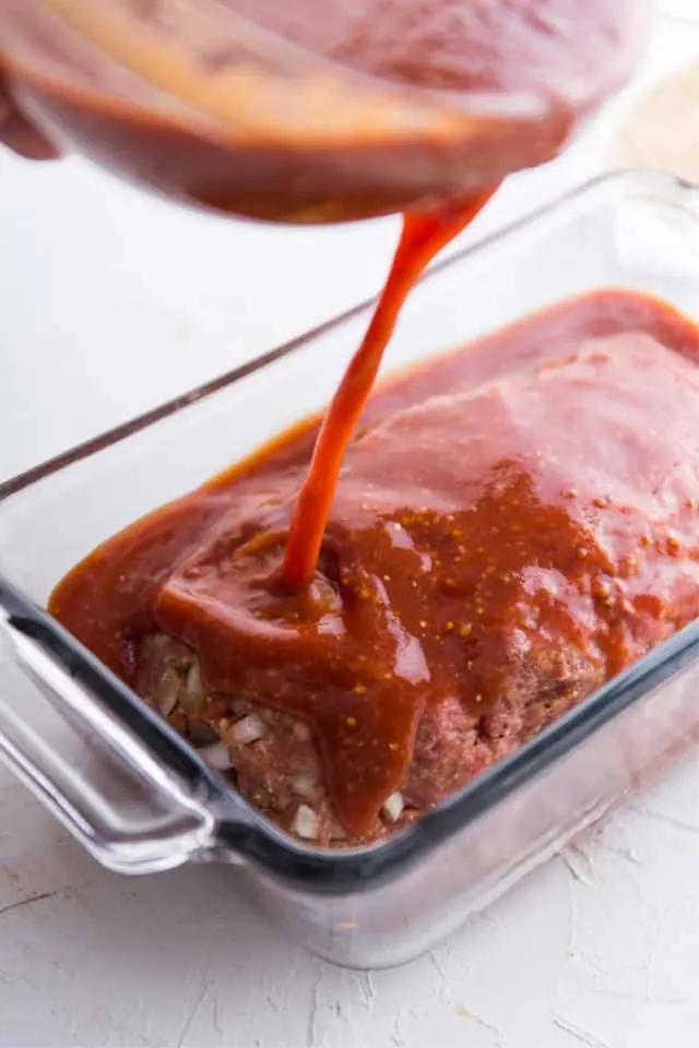 Adding sauce to the tasty easy meatloaf 
