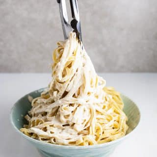 A photo of the noodles having the sauce worked in.