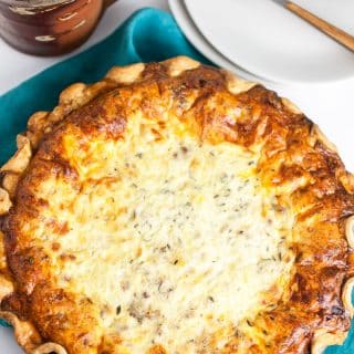 A photo of Meat Lovers Quiche with a plate and napkin