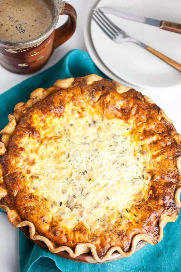 A photo of Meat Lovers Quiche with a plate and napkin