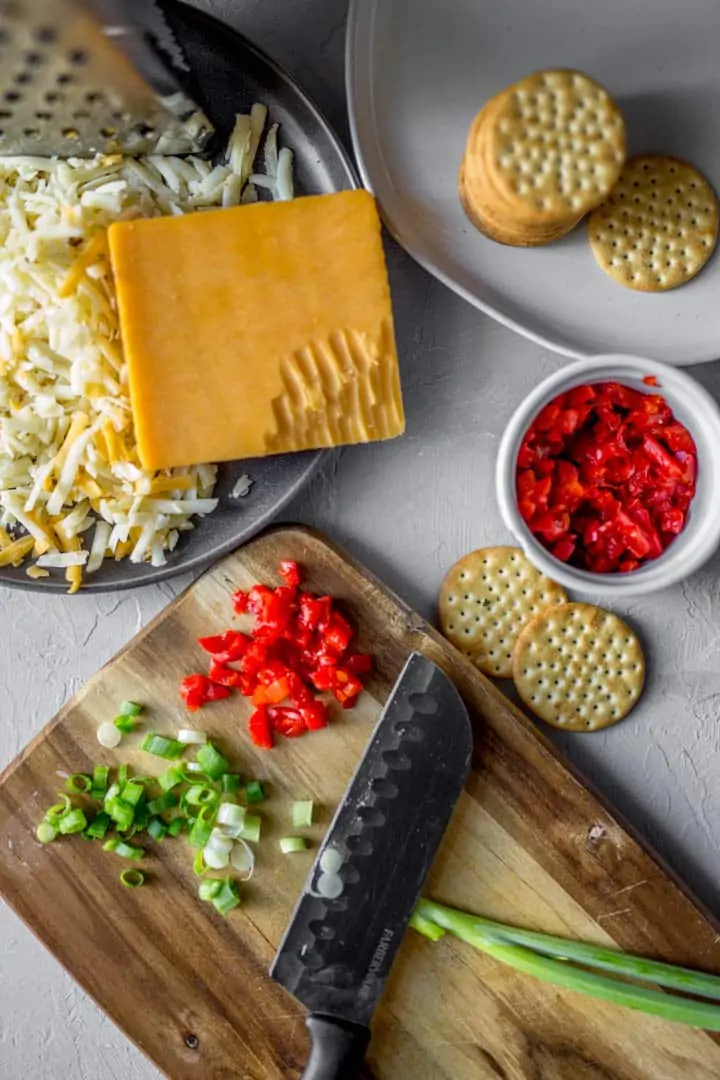 cheese grated, crackers, pimentos and green onion