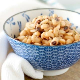 A close up view from the side of a bowl of black eyed peas for How to cook canned black eyed peas