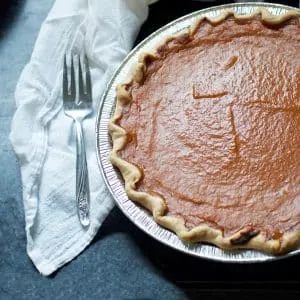 The pie with a fork and napkin for HOW TO MAKE PUMPKIN PIE WITH CANNED PUMPKIN PIE MIX