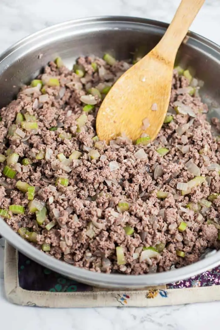 A photo of a pan of burger with celery and onions for homemade sloppy joe sauce