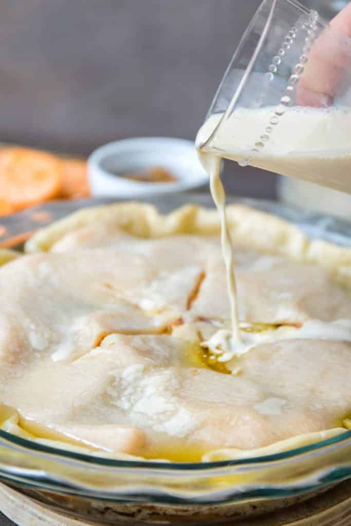 Adding the evaporated milk to the sweet potato cobbler