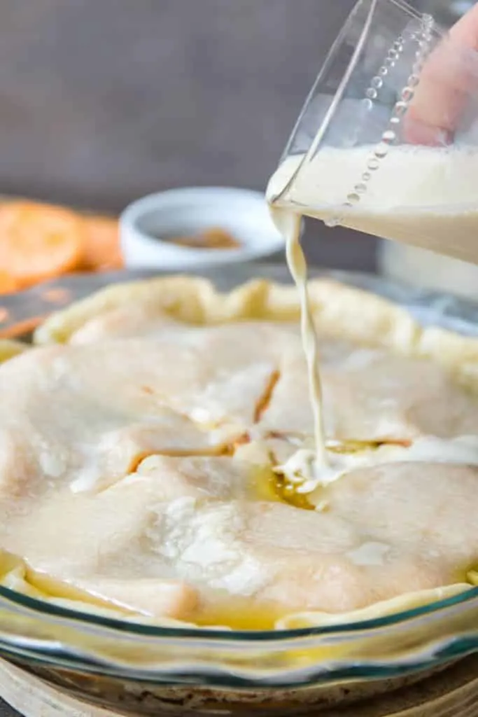 Adding the evaporated milk to the sweet potato cobbler