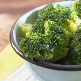 A close up photo of a bowl of broccoli