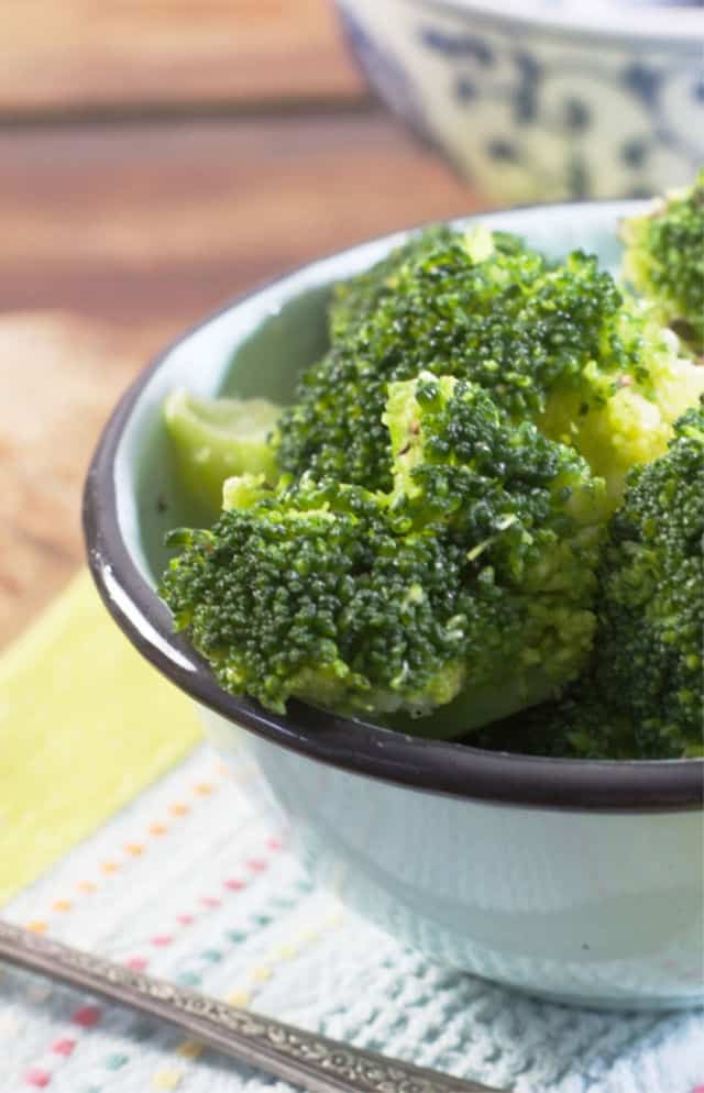 A close up photo of a bowl of broccoli