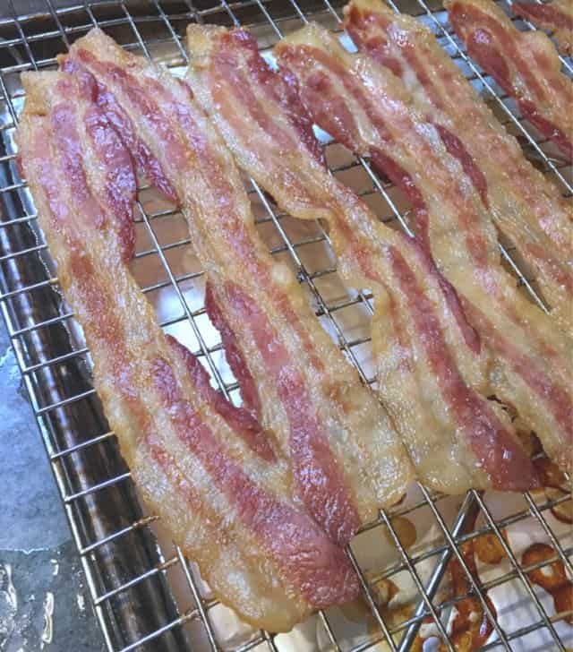  A photo of oven cooked bacon on a rack in a pan