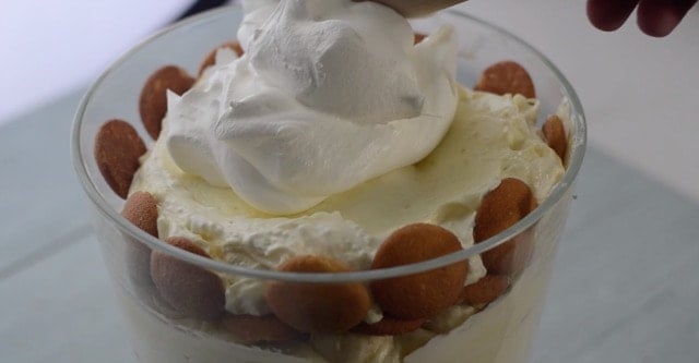 Cool whip being spread on the top of mawmaws banana pudding