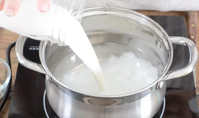 Adding milk to the heating water