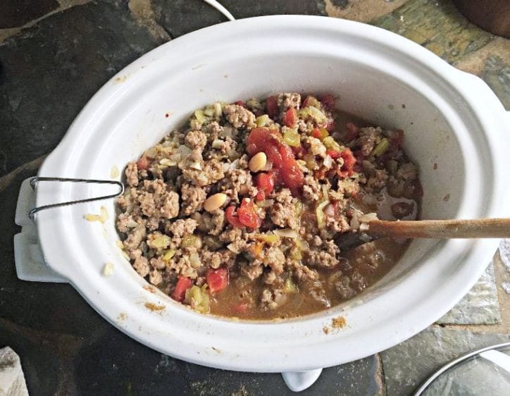 A crockpot of pinto bean soup ready to cook