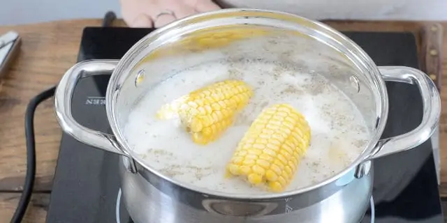 Frozen corn cobs added to the heating liquids and spices