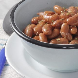 A close up of some kidney beans in a blue bowl with a black rim