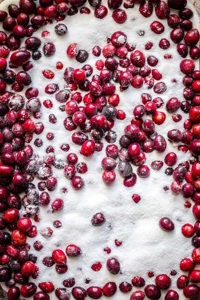 a close up of the white sugar on top of the fresh cranberries