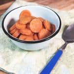 A blue bowl of carrots with blue spoon