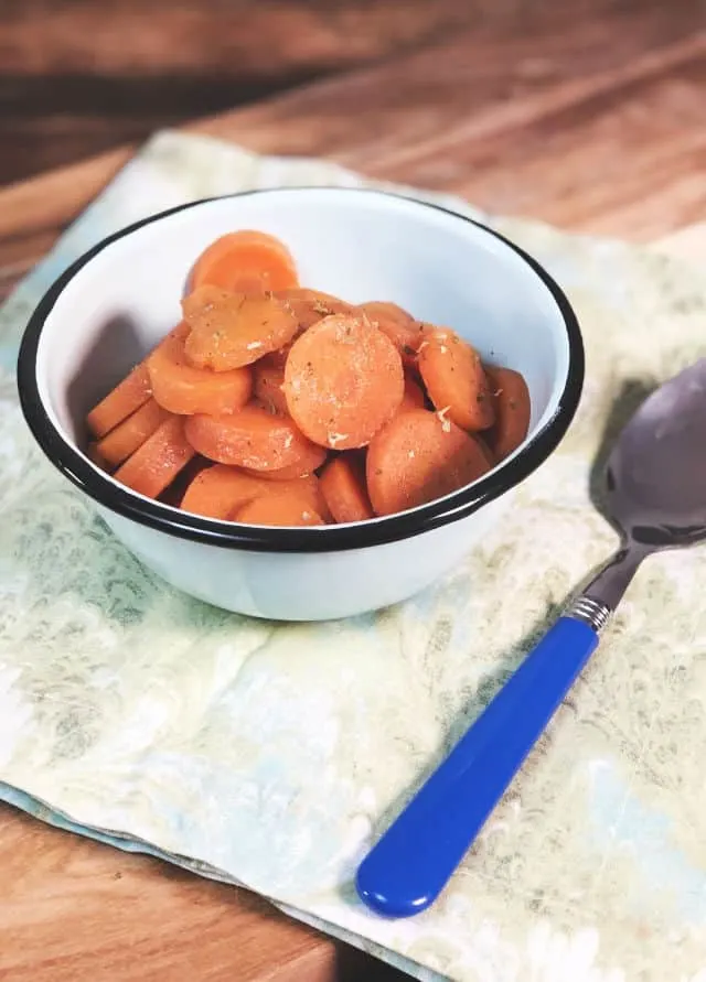 A blue bowl of carrots with blue spoon
