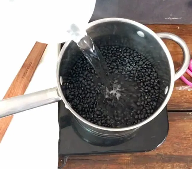 Adding water to cover the beans