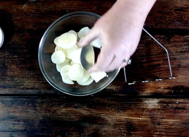 Adding the spices to the potatoes and butter