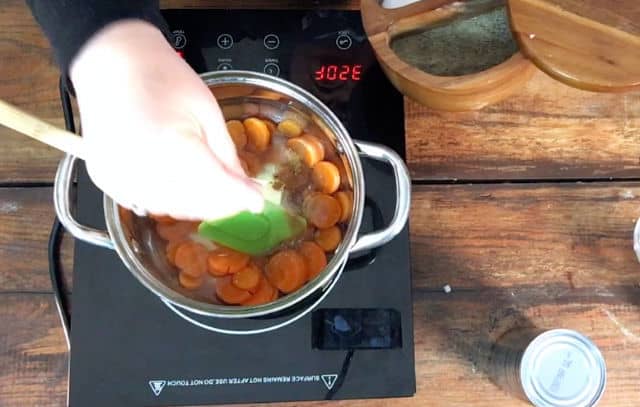 adding salt and pepper to the carrots