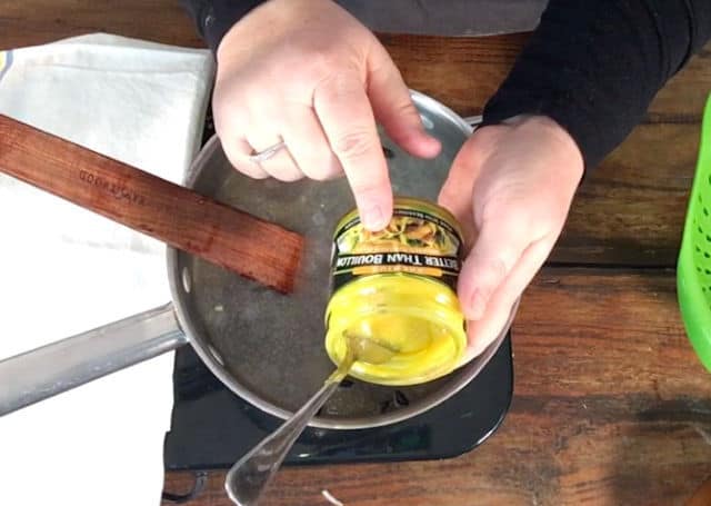 a photo of wendi adding the seasonings to the bean mix