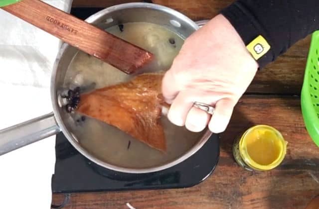 Adding the turkey wing to the saucepan