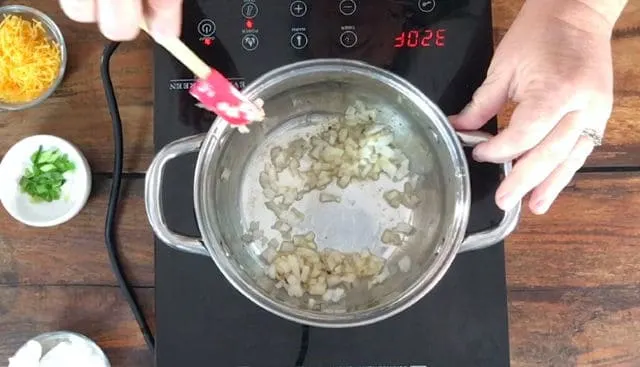 Cooking the onions in bacon grease in the sauce pan for best canned refried beans