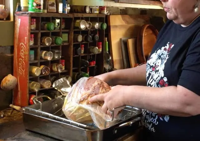A photo of Wendi unwrapping a ham from the shrink wrap