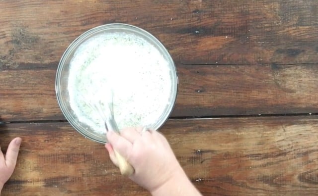 Whisking the mayonnaise, milk and ranch dressing together in a glass bowl