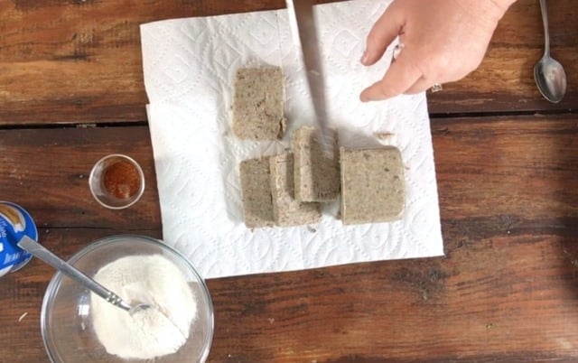 cutting the raw scrapple into slices