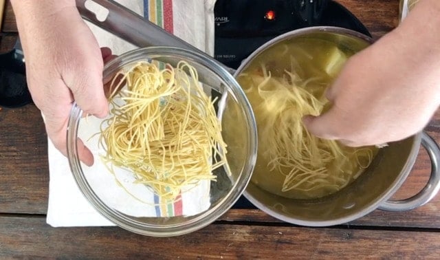 photo of adding more noodles to the soup
