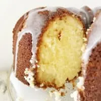 A view into the cut pound cake with glaze dripping down the side