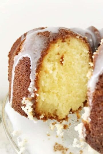 A view into the cut pound cake with glaze dripping down the side