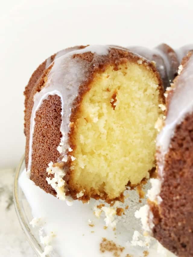 A view into the cut pound cake with glaze dripping down the side