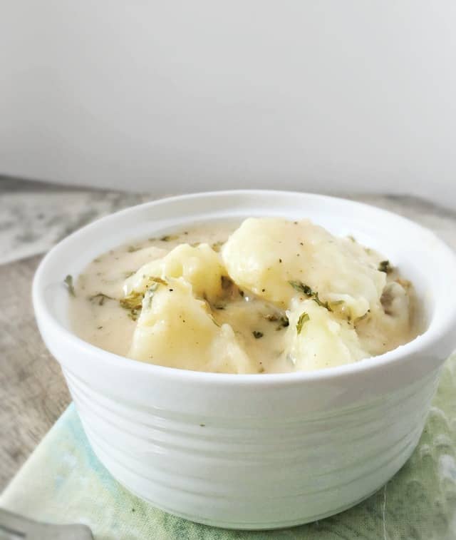 Side view of white bowl of this recipe on a green napkin