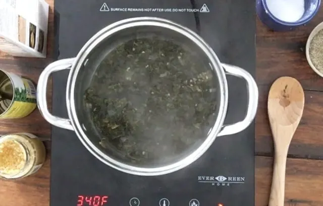 Saucepan heating with steam rising on burner
