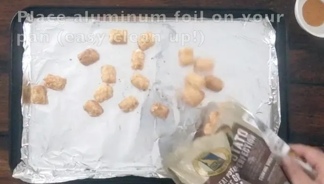 Frozen Tater Tots being poured out of a bag onto a baking sheet.
