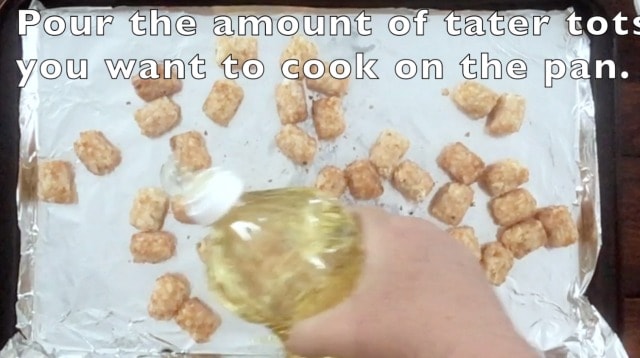 hand pouring vegetable oil on the baking sheet for cooking