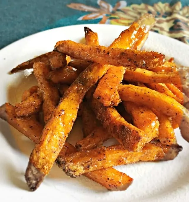 white plate on blue table cloth with sweet potato fries