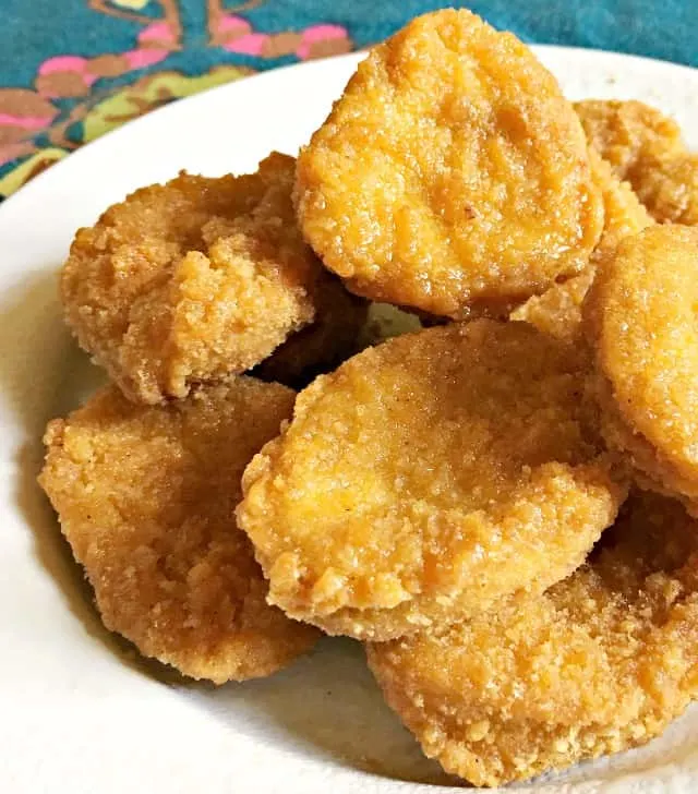 White plate holding a pile of chicken nuggets