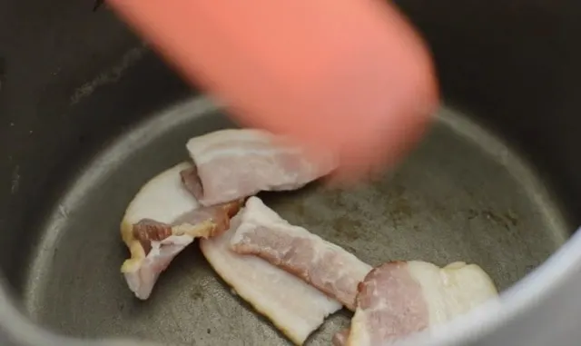 Bacon frying in sauce pan