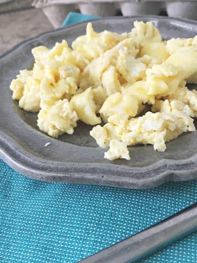 side view gray plate with microwave eggs and blue napkin