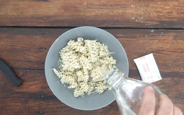 water being poured over the dried noodles