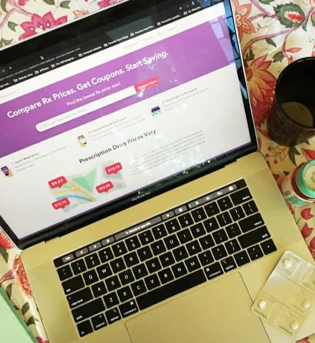 overhead shot of laptop with RxSaver pulled up, coffee mug and pill bottle