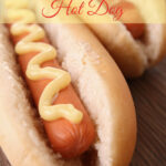 hot dog with bun and mustard