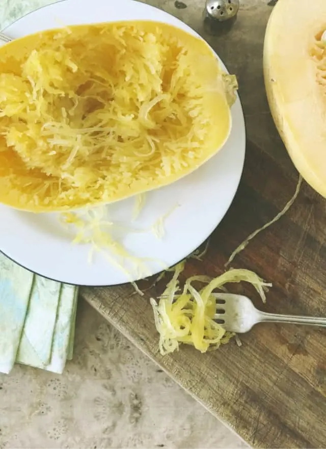 close up of the inside of the spaghetti squash and a fork