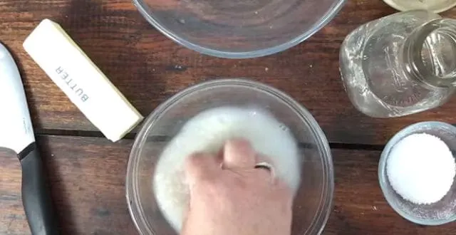 hand in bowl swishing rice around to wash it 